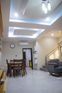 a living room with a table and a dining room at Monga's Apartments in Ndola