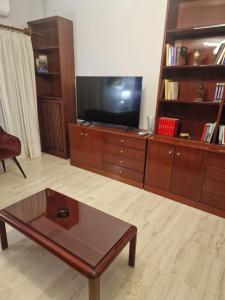 a living room with a tv and a coffee table at Nicolas luxury apartment in Amalias