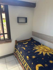a bedroom with a bed with a blanket on it at Vilarejo do farol in Praia do Forte +32 photos