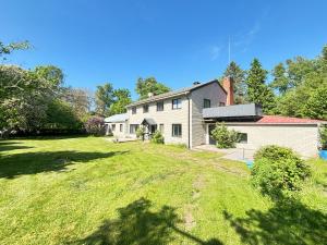 a house with a large yard in front of it at B&B Villa Vila in Löttorp