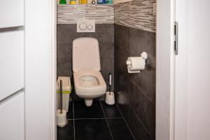 a bathroom with a toilet in a small room at The white Nest Apartment AC & Balcony in Bratislava +6 photos