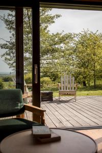 a porch with a rocking chair and a table at Hyttee in Bardo