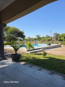 a view of a swimming pool from the porch of a house at Stegor Suites in Maun