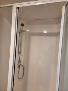 a shower in a bathroom with a glass door at 2 bedrooms caravan with a sea view in Poole +13 photos