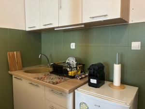 a kitchen with a sink and a counter top at Budva Apartment with Private Parking in Budva