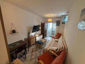 a living room with a couch and a table at Budva Apartment with Private Parking in Budva