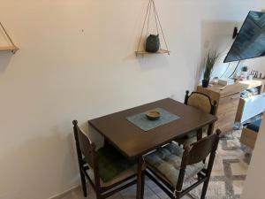 a dining room with a wooden table and chairs at Budva Apartment with Private Parking in Budva