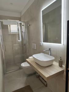 a bathroom with a sink and a toilet and a shower at Studio apartman Fabi in Novigrad Istria