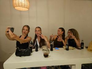 a group of three women sitting at a table brushing their teeth at Hi Sea Hostel - Boutique Style in Center, 15 min Walk from Pier in Thong Sala