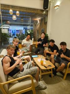 a group of men sitting in chairs in a room at Hi Sea Hostel - Boutique Style in Center, 15 min Walk from Pier in Thong Sala +26 photos