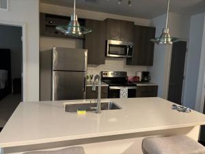a kitchen with a sink and a stainless steel refrigerator at King Blue Oasis in Madison