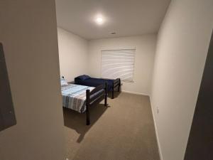 a small bedroom with a bed and a window at King Blue Oasis in Madison