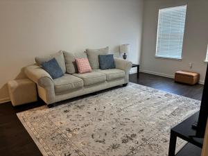 a living room with a couch and a rug at King Blue Oasis in Madison