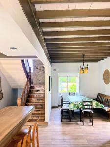 a dining room with a table and chairs and a staircase at Casa Rua in Lira
