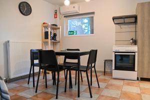 a kitchen with a table and chairs in a room at West of Preveza Luxury Jacuzzi Apartment in Preveza +10 photos