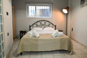 a bedroom with a bed with two pillows on it at West of Preveza Luxury Jacuzzi Apartment in Preveza
