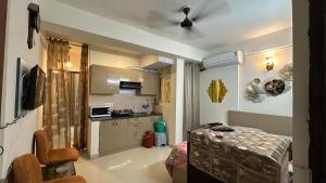 a kitchen with a table and a ceiling fan at THE NEST - Kingdom in Ghaziabad +4 photos