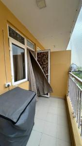 a room with two windows and a bed on a balcony at THE NEST - Kingdom in Ghaziabad