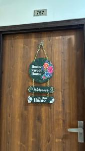 a sign on a door that says home sweet home and welcome to my home at THE NEST - Kingdom in Ghaziabad