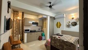 a kitchen with a table and a ceiling fan at THE NEST - Kingdom in Ghaziabad