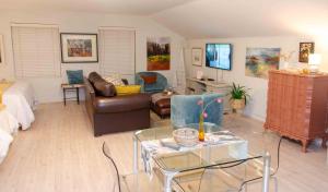 a living room with a couch and a table at Art and Accommodation Guesthouse in Cape Town