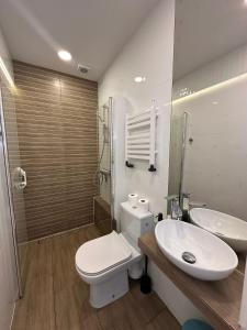 a bathroom with a toilet and a sink at Na Kwiatkowskiego in Sandomierz +25 photos