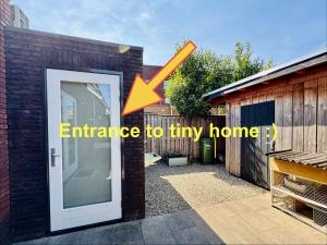 an entrance to a tiny home with an open door at Stylish private-entrance studio with bath and shower near Nijmegen Centre and Arnhem Zuid in Nijmegen