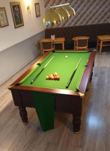 a pool table with balls on top of it at The Saltley Inn in Birmingham