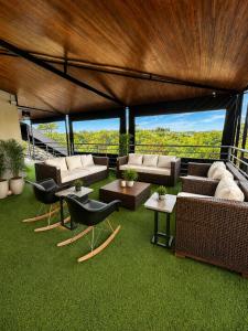 a living room with couches and tables and grass at ibis Catanduva in Catanduva