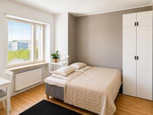 a bedroom with a bed and a window at Gallen-Kallelankatu 9 in Pori