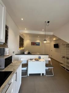 a kitchen with a white counter and a table at La Perla Marina in Manarola +10 photos