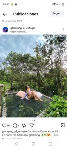 a woman sitting in a pool of water at Bio Hotel - Eco Glamping El Refugio in Gigante