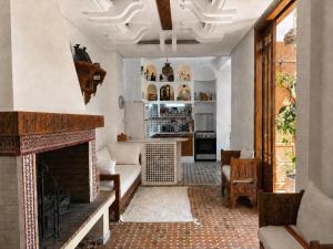 a living room with a fireplace and a couch at Bright Riad with Panoramic Views - Oudayas in Rabat