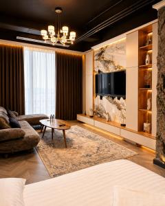 a living room with a couch and a table at NestOne - Apartment hotels in Tashkent