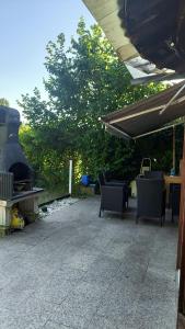 a patio with chairs and a grill and a table at Chez Carolayn in Geneva