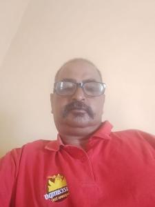 a man in a red shirt with a mustache at Appartement chez bennouri in Telouet