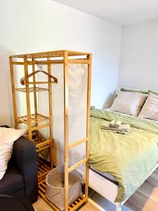 a bunk bed with a ladder next to a bed at Stylish private-entrance studio with bath and shower near Nijmegen Centre and Arnhem Zuid in Nijmegen