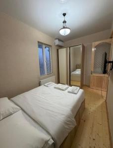 a bedroom with two beds and a mirror at Villa Cypress in Kutaisi +32 photos