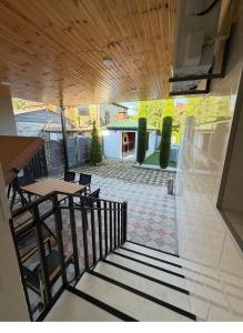 a balcony with a table and chairs and a patio at Villa Cypress in Kutaisi