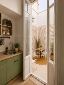 a kitchen with a door open to a patio with a table at Van Gogh Luxury Flat By CH Luxury Apartments in Alicante +13 photos
