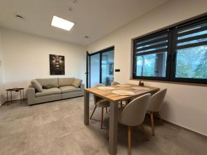 a living room with a table and chairs and a couch at Black Diamond Apartments in Kobylnice