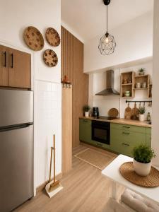 a kitchen with green cabinets and a white refrigerator at Van Gogh Luxury Flat By CH Luxury Apartments in Alicante