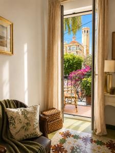 a living room with a chair and a sliding glass door at Van Gogh Luxury Flat By CH Luxury Apartments in Alicante