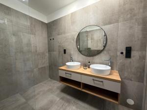 a bathroom with two sinks and a mirror at Black Diamond Apartments in Kobylnice +12 photos