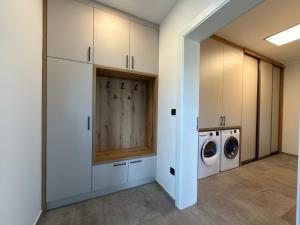 a laundry room with a washer and dryer at Black Diamond Apartments in Kobylnice