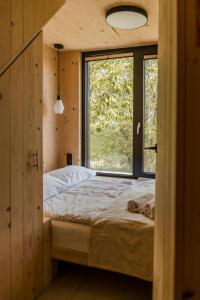 a bedroom with a bed with a large window at Hyttee in Bardo
