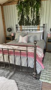 a metal bed with pillows on it in a room at Tregantle Farm Eco GLAMPSITE in Torpoint +79 photos