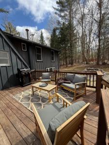 a deck with chairs and a grill on a house at The Remington House in Woodruff