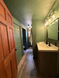 a bathroom with a sink and a mirror at The Remington House in Woodruff +15 photos