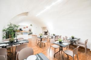 a dining room with tables and chairs and a fireplace at Hotel Paradise Rooms in Bitritto